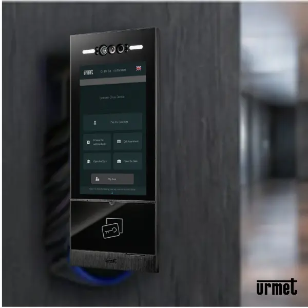 URMET ONYX video door station installed on a wall, showing its 10-inch touchscreen interface and facial recognition cameras